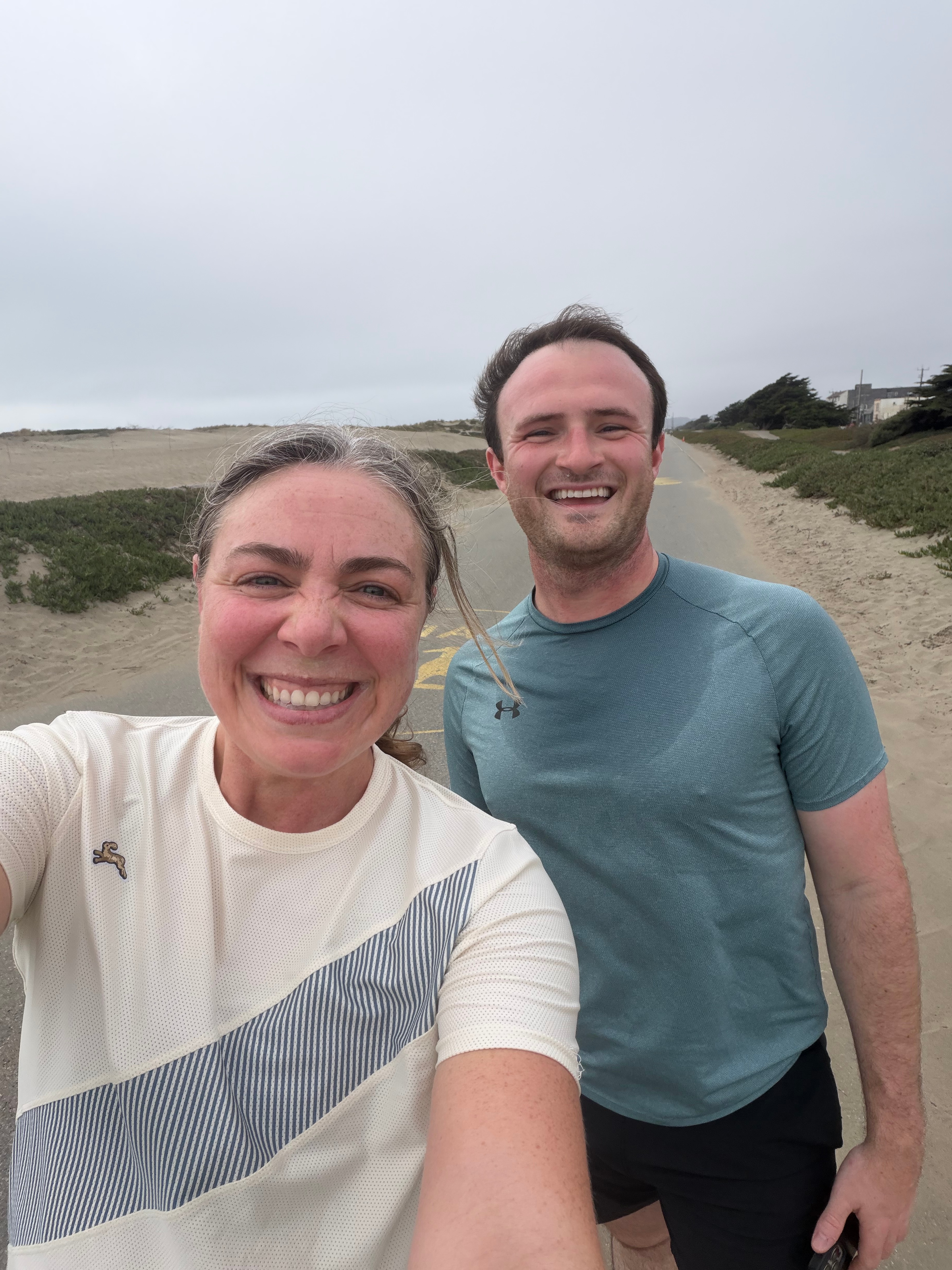 Selfie with my coworker turned friend Henry on a beach path in running gear